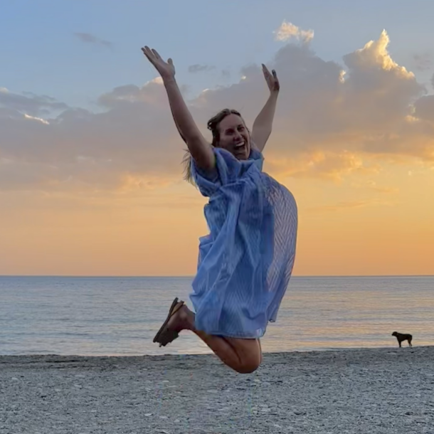 enneagram types explained — woman with arms raised at sunset