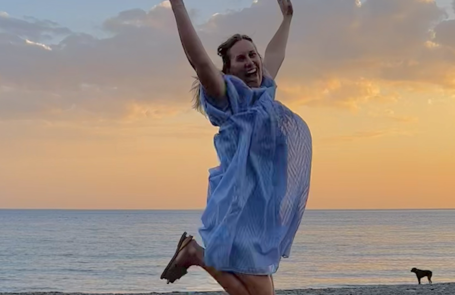 enneagram types explained — woman with arms raised at sunset