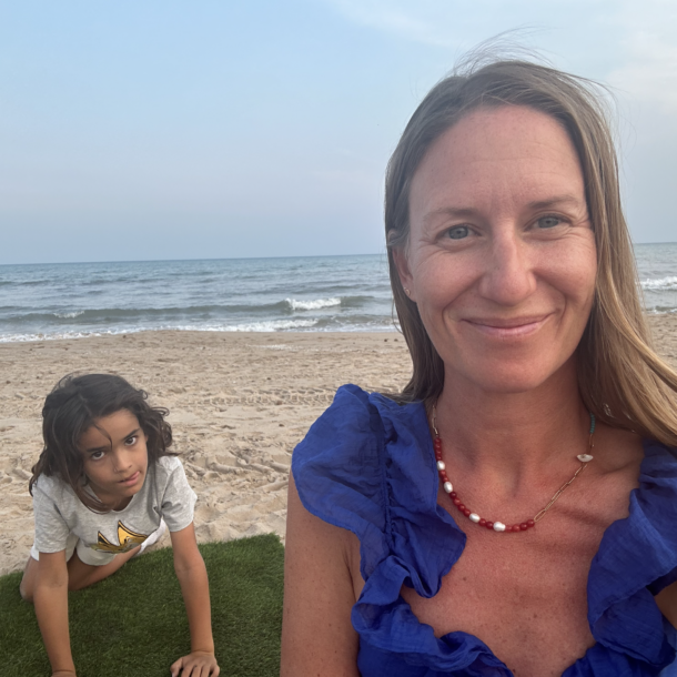 Child sitting alone on the beach, showing quiet signs of child stress by Enneagram type
