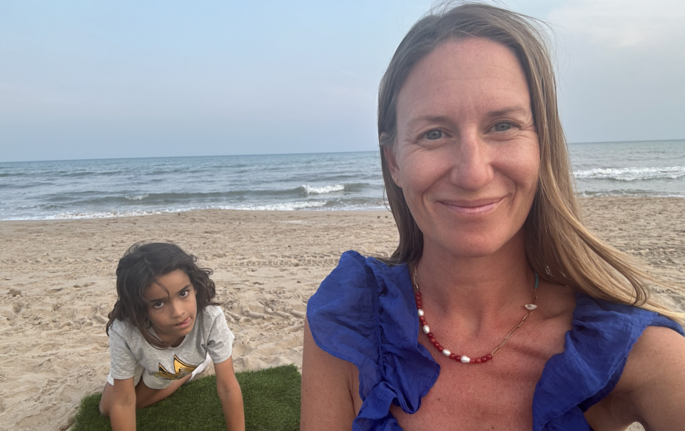 Child sitting alone on the beach, showing quiet signs of child stress by Enneagram type